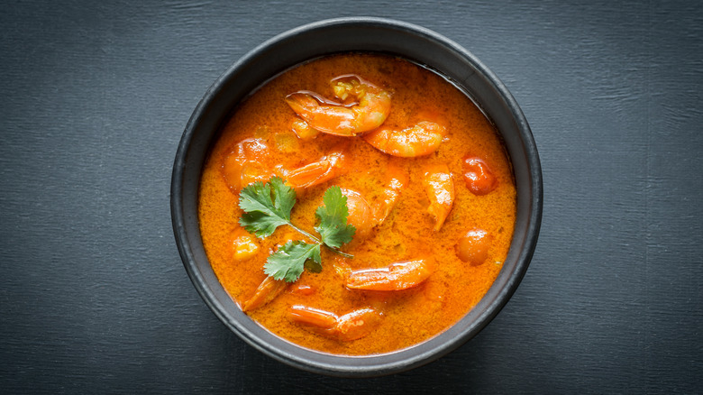 Seafood curry in black bowl