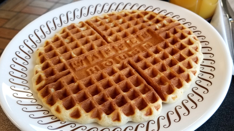 Waffle House sign against blue sky