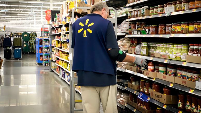 Walmart employee stocking shelves