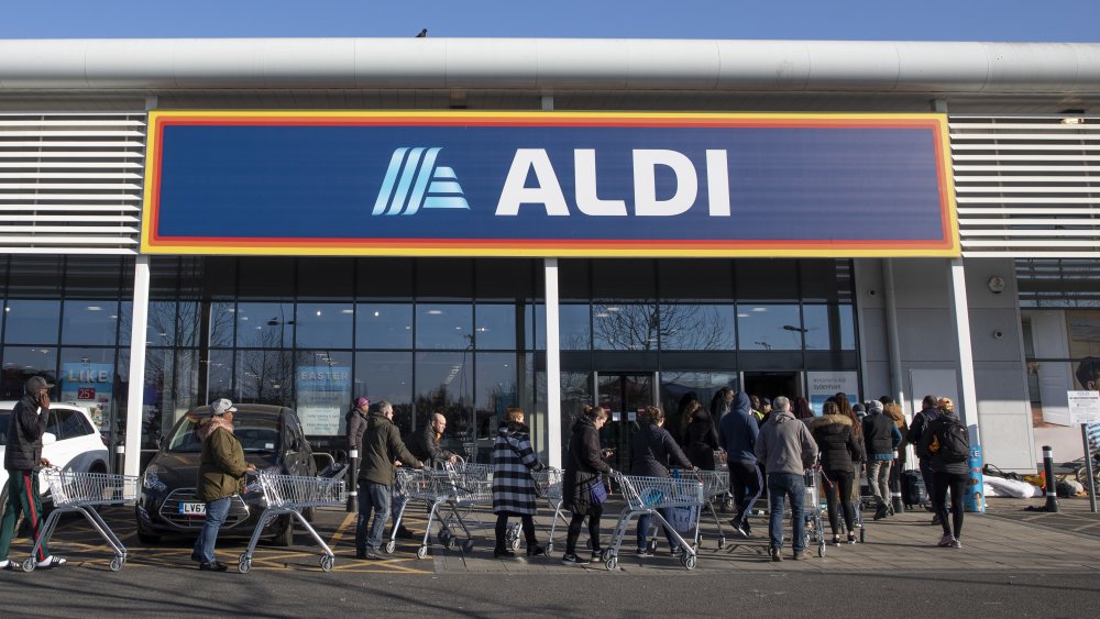 Customers line up in front of Aldi