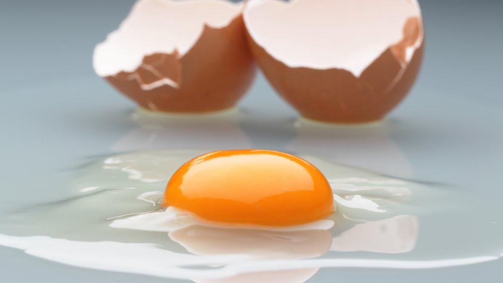 Cracked raw egg with yolk