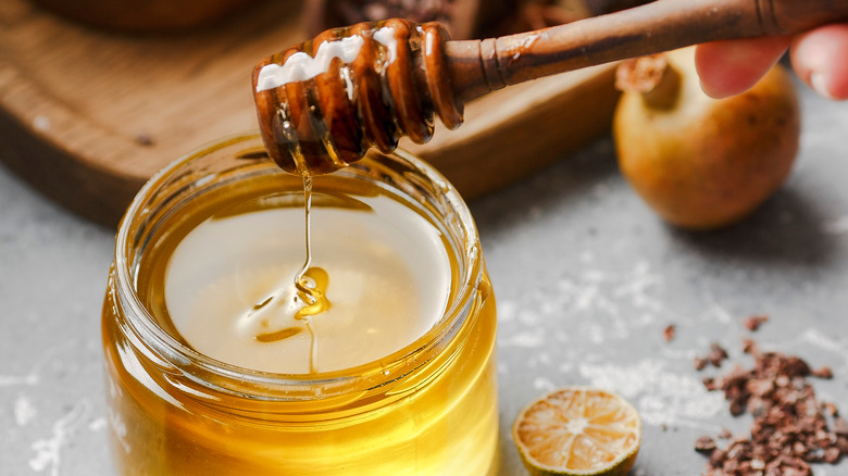 Honey in jar with wooden spoon