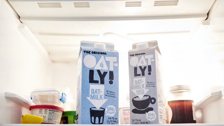 Oat milk in gray cartons in a fridge