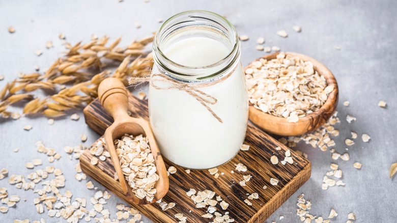 Oat milk on brown wood