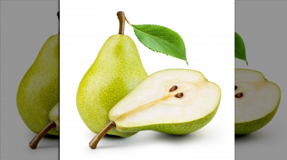 Whole and cut green pear