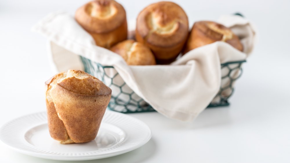 Basket of popovers with one on a plate