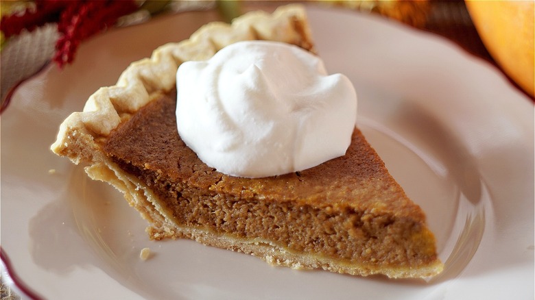 Pumpkin pie slice with whipped cream