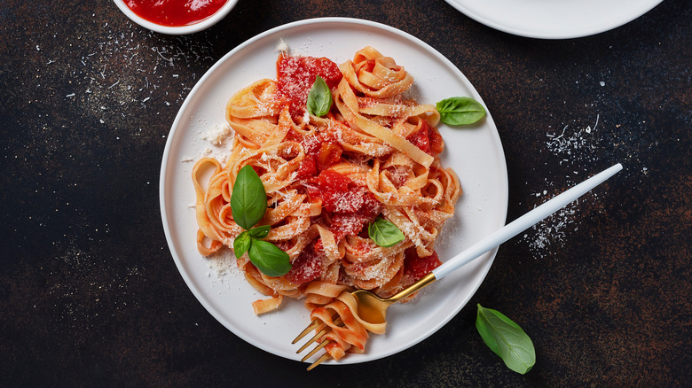 Pasta covered in sauce and basil