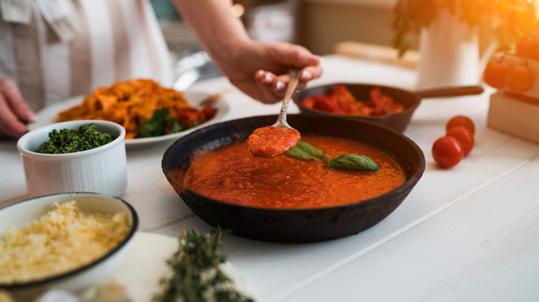 Red sauce in a black bowl