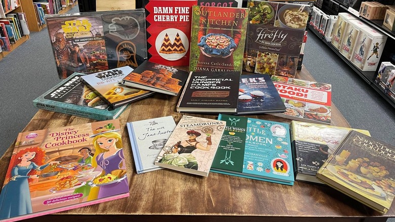 A table filled with pop culture cookbooks 