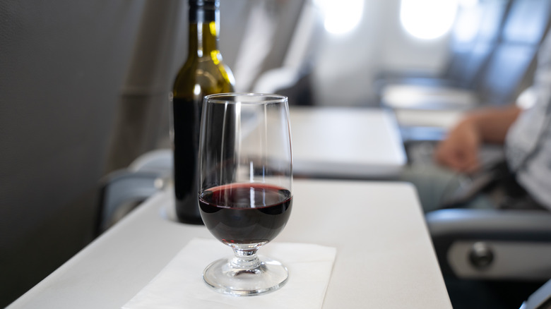 A glass of wine served on an airplane