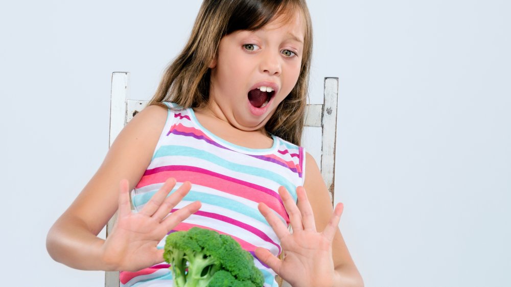 Girl refusing broccoli