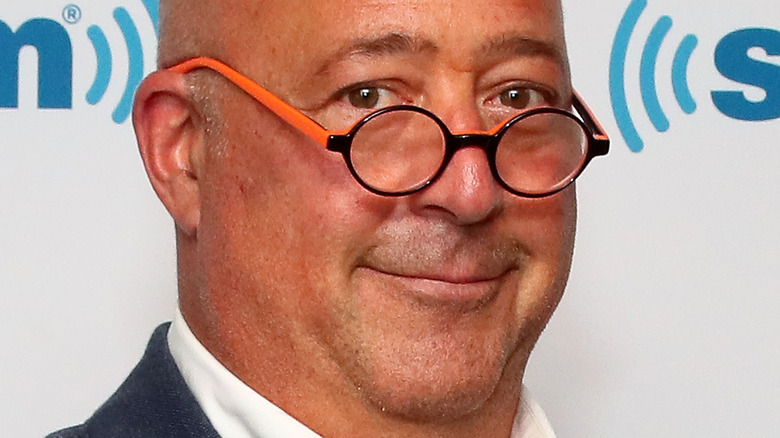 Andrew Zimmern wearing orange glasses