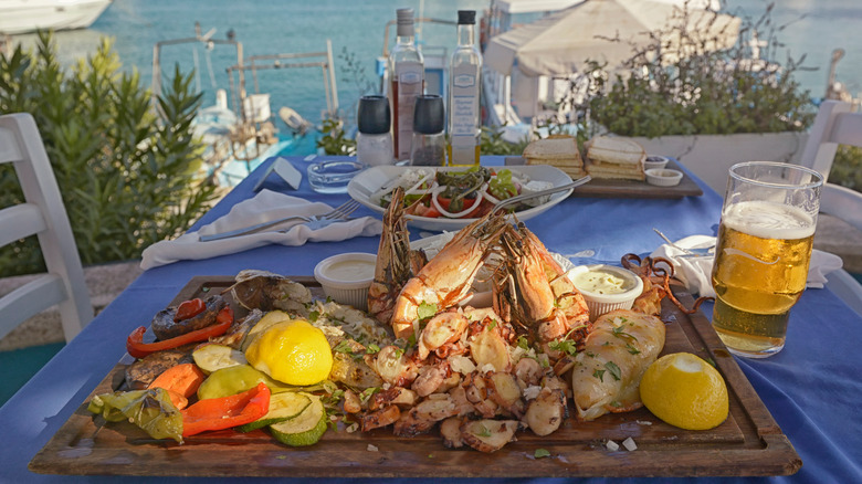 A seafood meal on a wooden tray overlooking the waters surrounding Cyprus