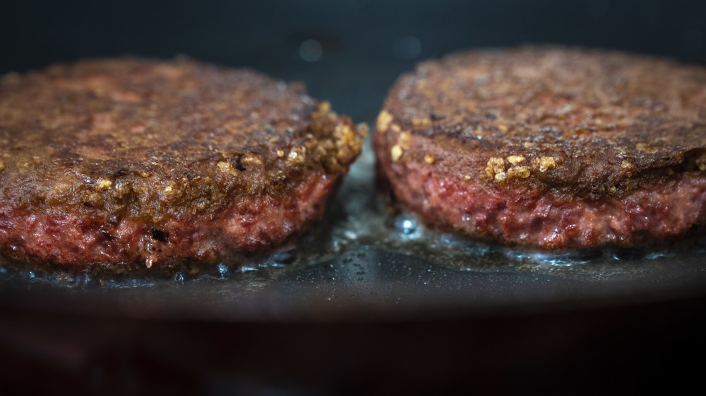 Two Beyond Meat patties sizzling in their precious... bodily... fluids.