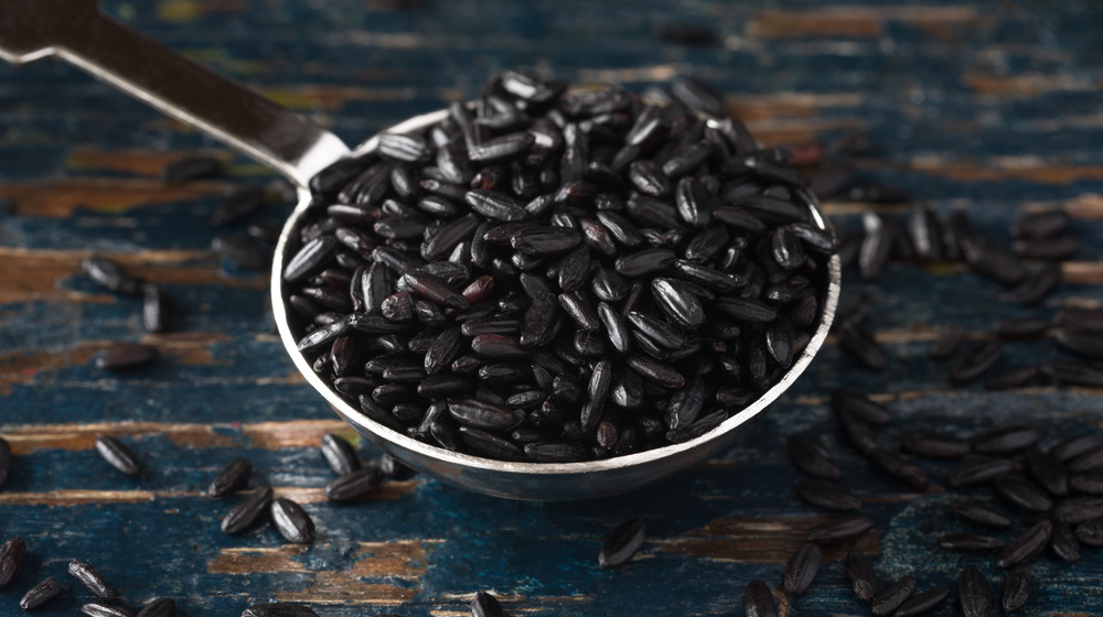 Black rice in a spoon