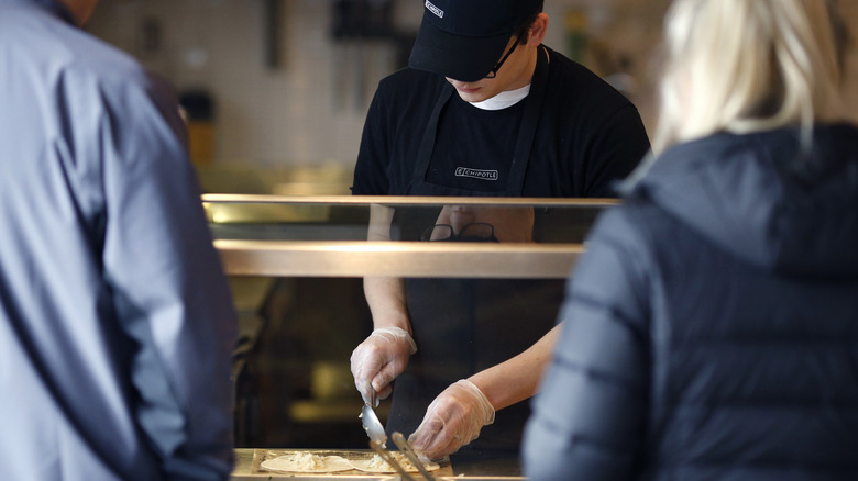Chipotle employee behind counter