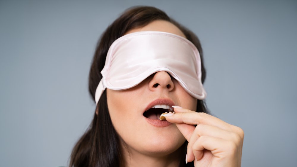 Woman biting into mysterious food