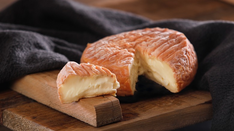 wheel of cut epoisses cheese