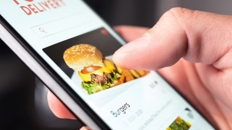 thumb choosing burger on app