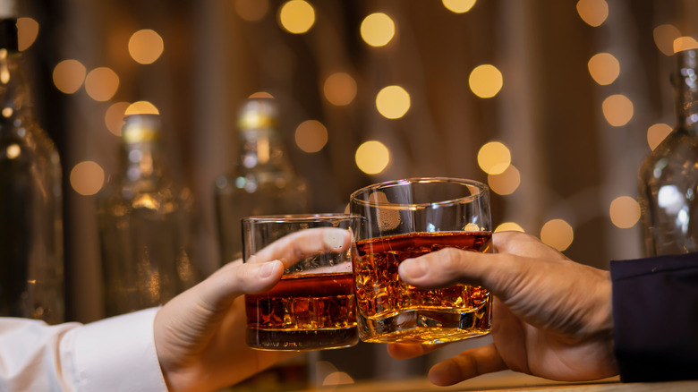 Friends toasting with whiskey