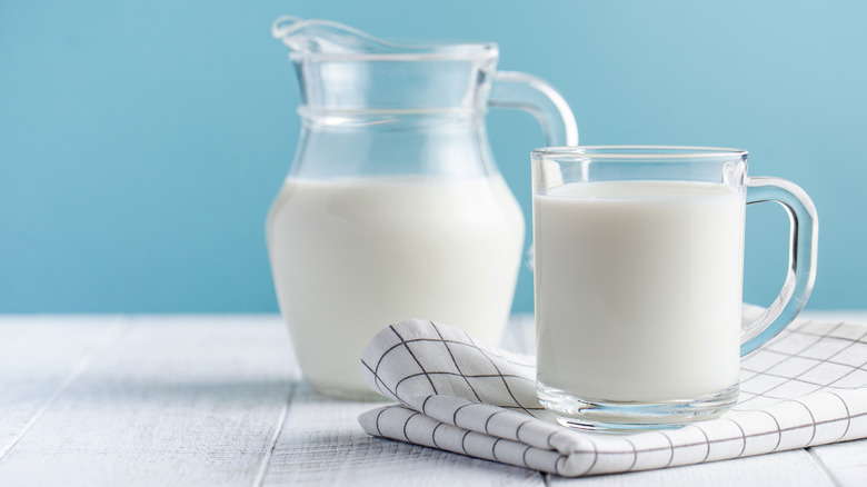 glass and jugs of milk