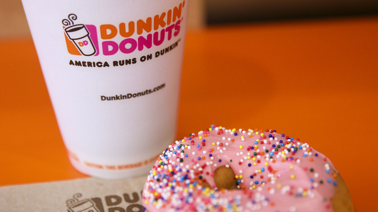 Dunkin' coffee cup and pink doughnut