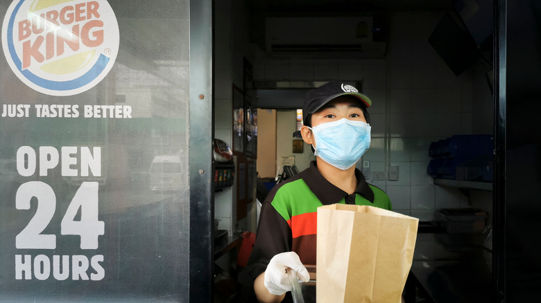 Burger King employee working the drive-thru