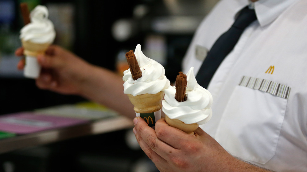 McDonald's worker holding vanilla cones