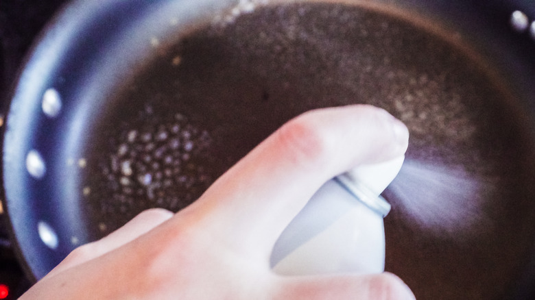 Adding cooking spray to a pan