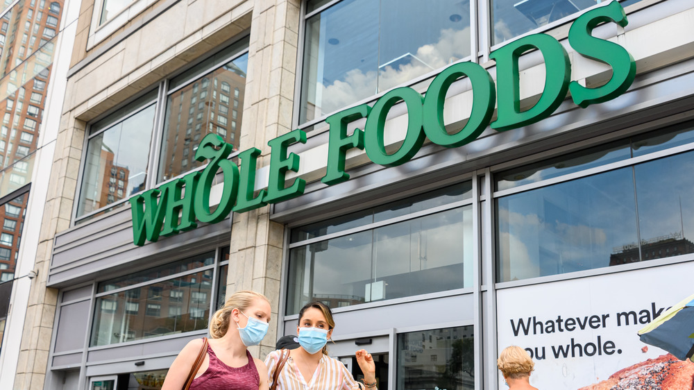 Passers-by outside a Whole Foods outlet