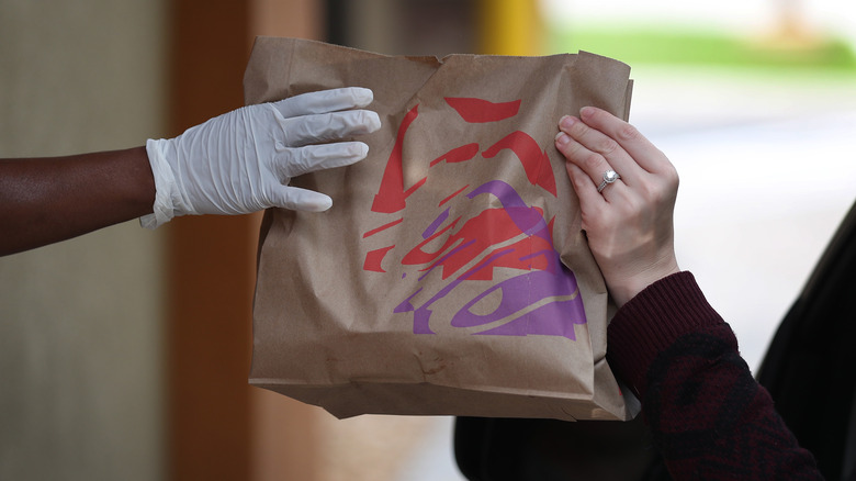 Taco Bell bag handed to customer at drive-thru