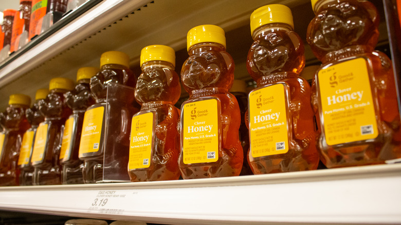 Row of honey bottles shaped like bears