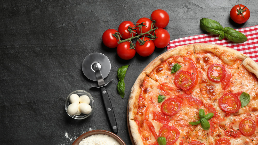 Italian pizza, ingredients, and tablecloth