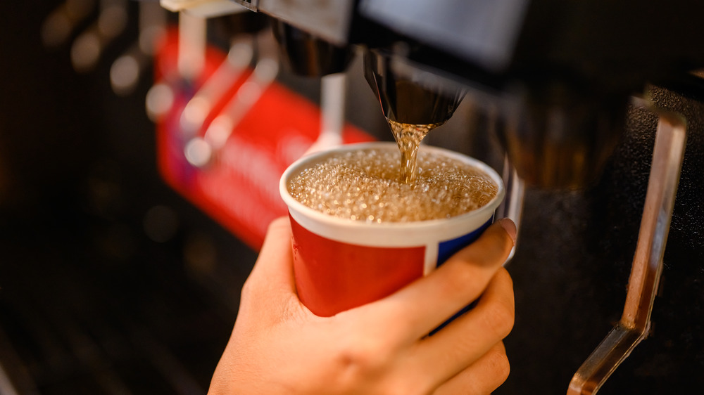 Soda pouring from machine into cup