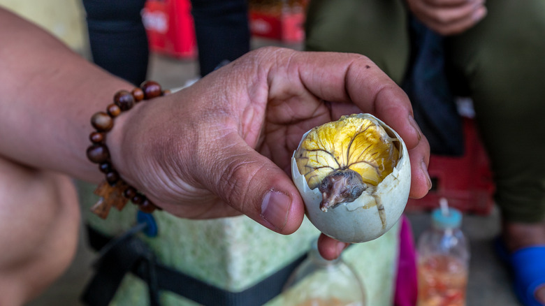 Hand holding balut