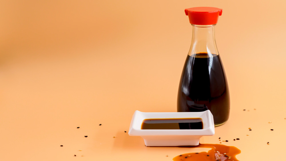 bottle of soy sauce on orange background