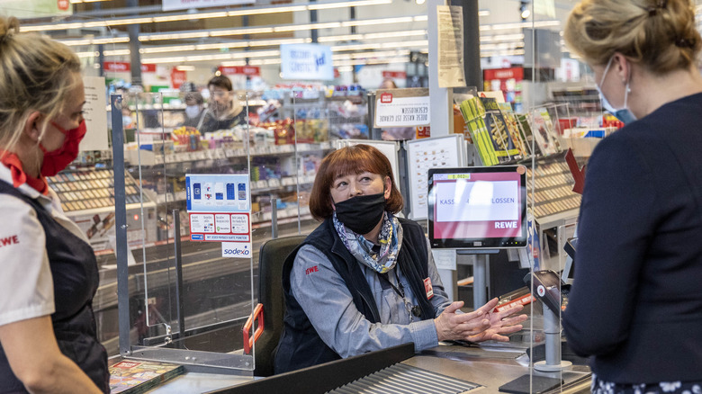 Cashier sitting at German grocer