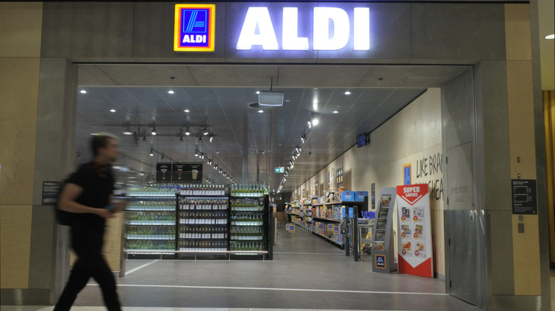 Person walking past Aldi entrance