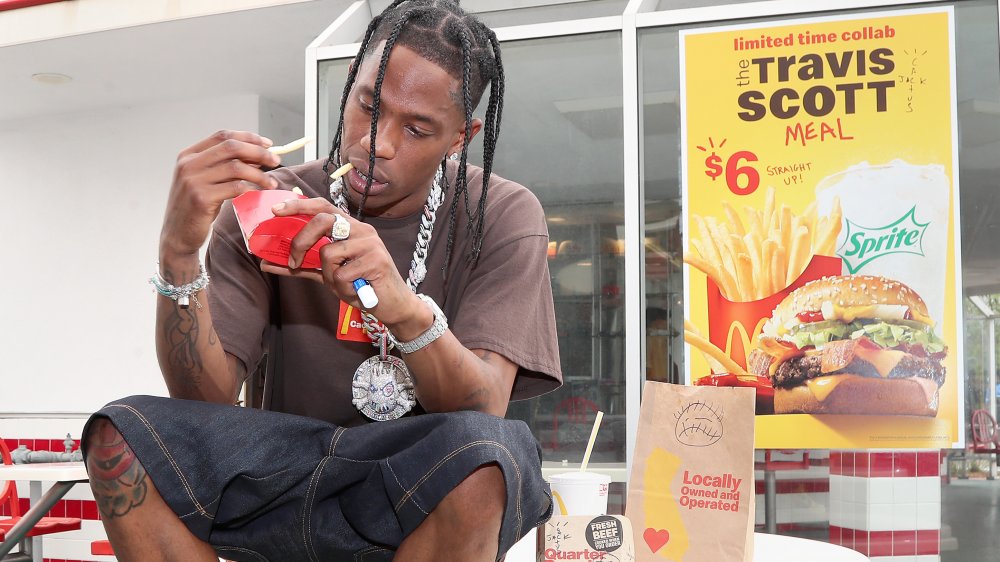 Travis Scott eating fries outside McDonald's