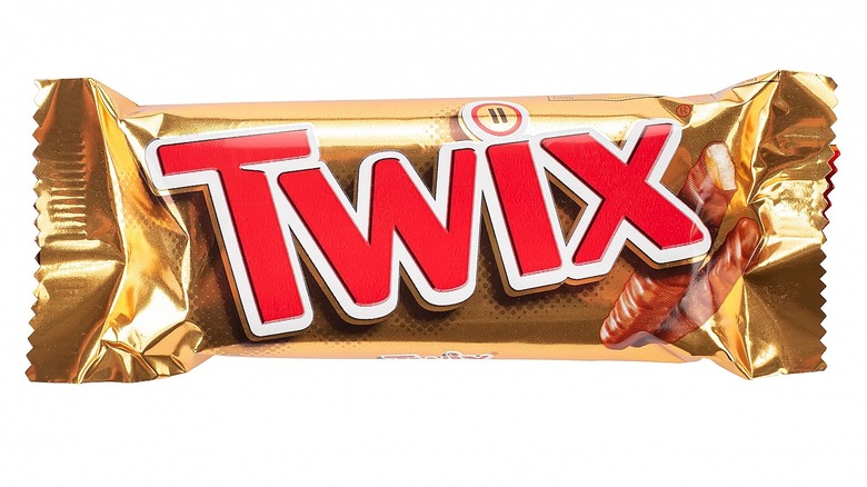 Red and gold Twix bar against white background