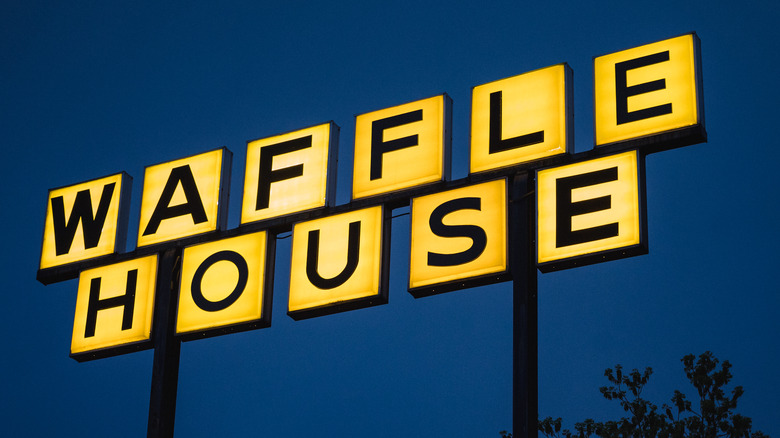 Waffle House sign and tree