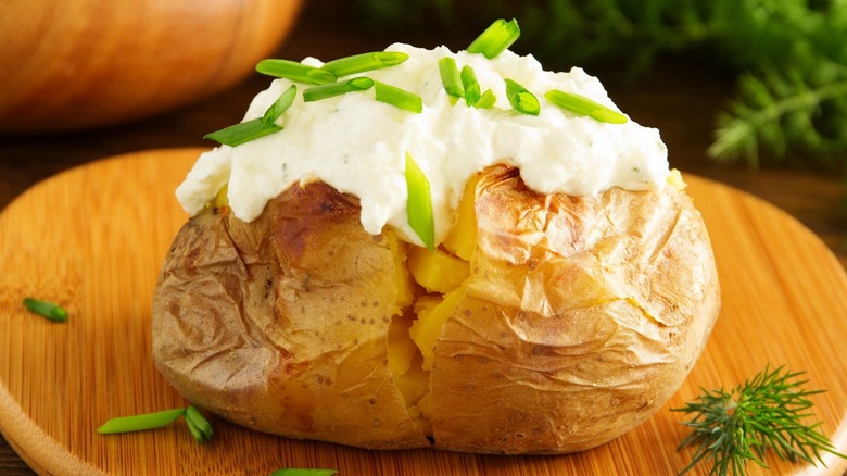 Baked potato topped with creamy sauce