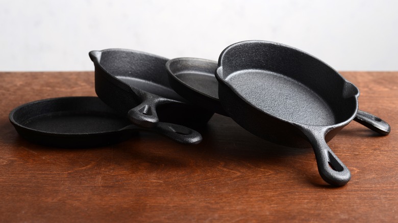 a few cast iron pans on the table