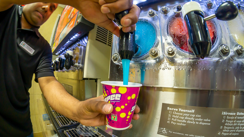 7-Eleven employee fills Slurpee