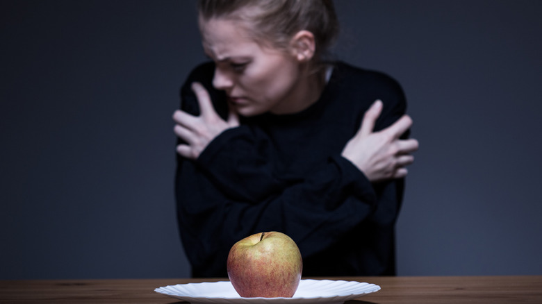 Woman afraid of apple