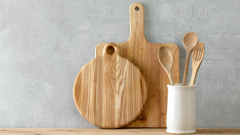 Cutting boards and spoons against wallpapered wall