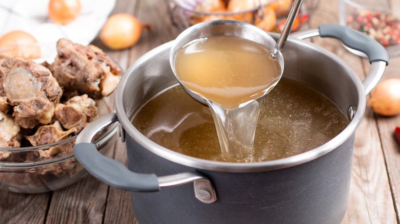 Stock being ladled into pot