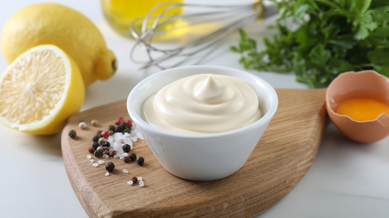 small bowl of mayonnaise on cutting board