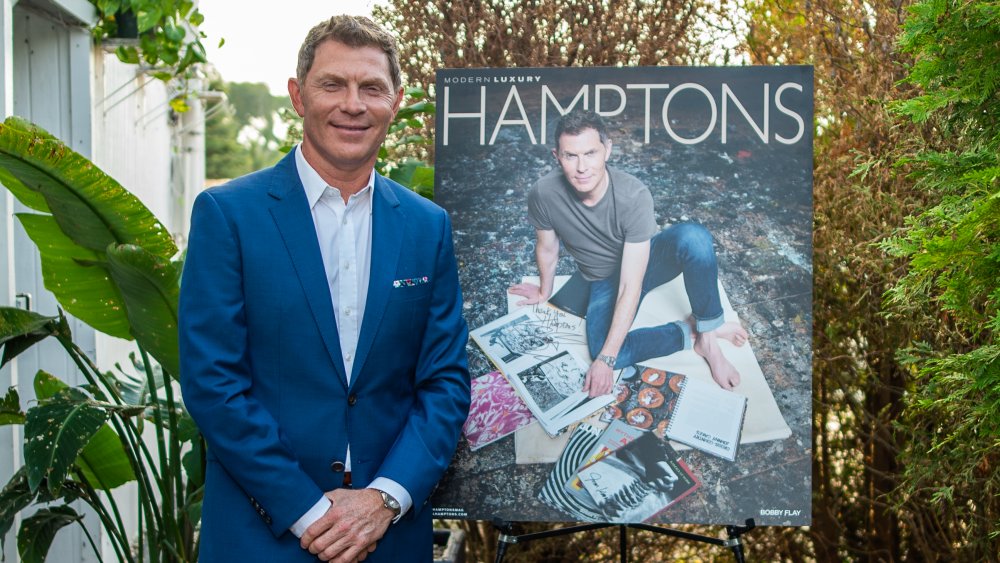 Bobby Flay in front of a poster